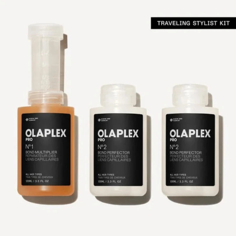 Three Olaplex hair care products on a white background with 'Traveling Stylist Kit' text.
