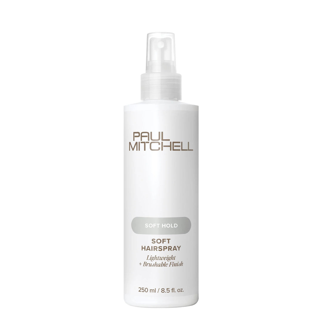 A white bottle of Paul Mitchell Soft Hairspray with a clear spray top, featuring gold and gray text on a clean white background.