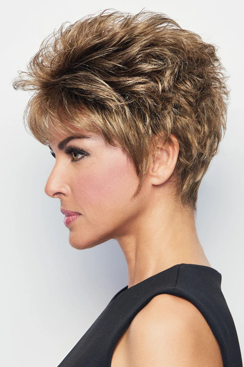 Woman with styled short hair against a plain background