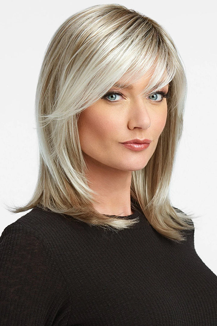 Woman with styled blonde hair against a white background