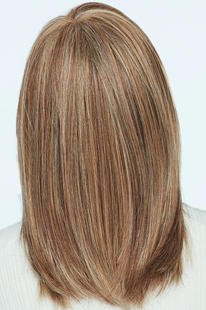 Blonde hair with brown roots styled in a straight cut on a white background