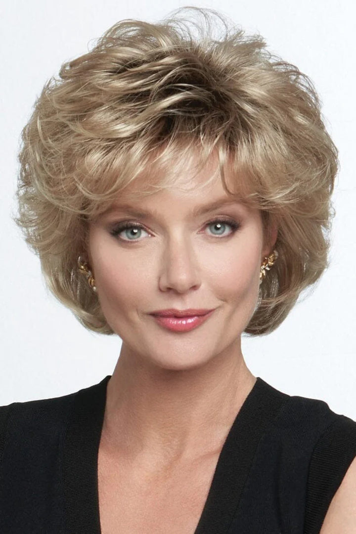 Woman with styled blonde hair against a white background