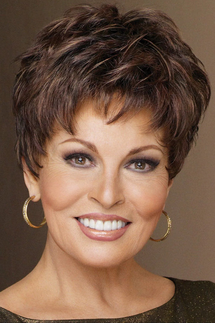 Woman with short, styled hair wearing gold hoop earrings against a brown background
