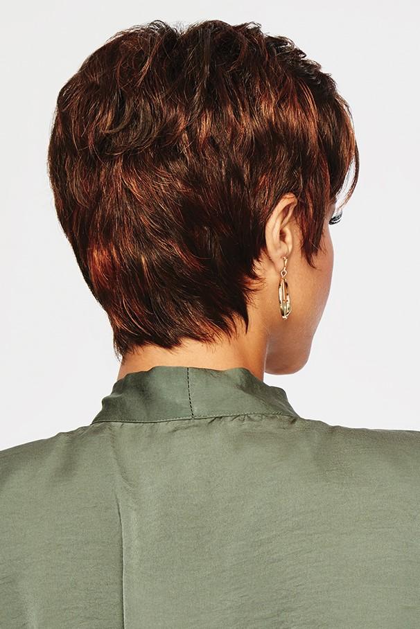 Back view of a person with short, styled hair wearing an olive green shirt on a light gray background
