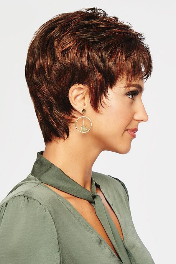 Woman with a stylish short haircut wearing a green shirt against a light background