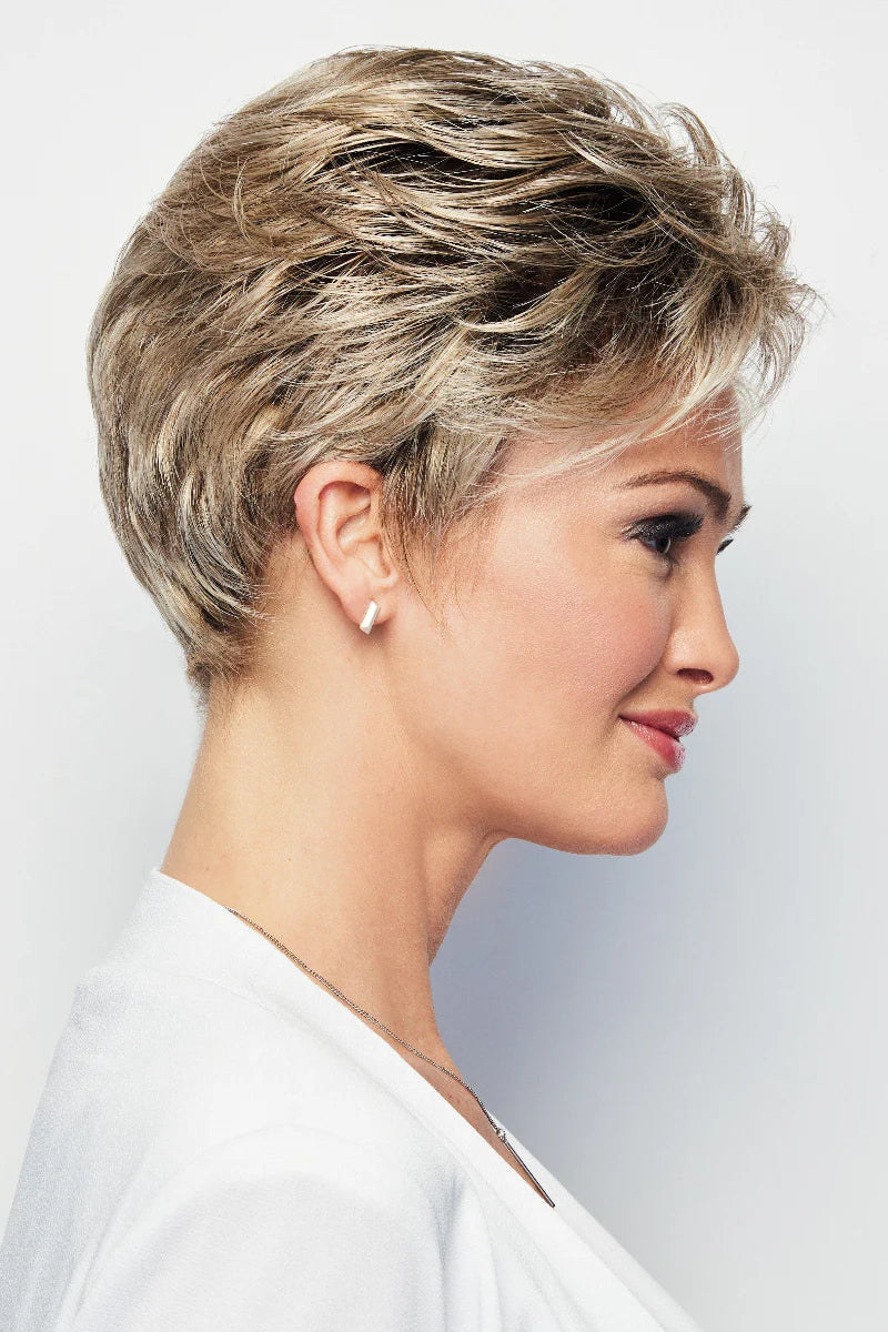 Woman with short, styled hair against a plain background