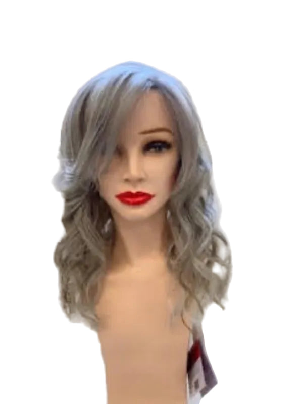 A shoulder-length wavy wig with cool gray and silver tones displayed on a mannequin head. The wig is shown against a light-colored brick wall background, with another mannequin partially visible in the background on the left.