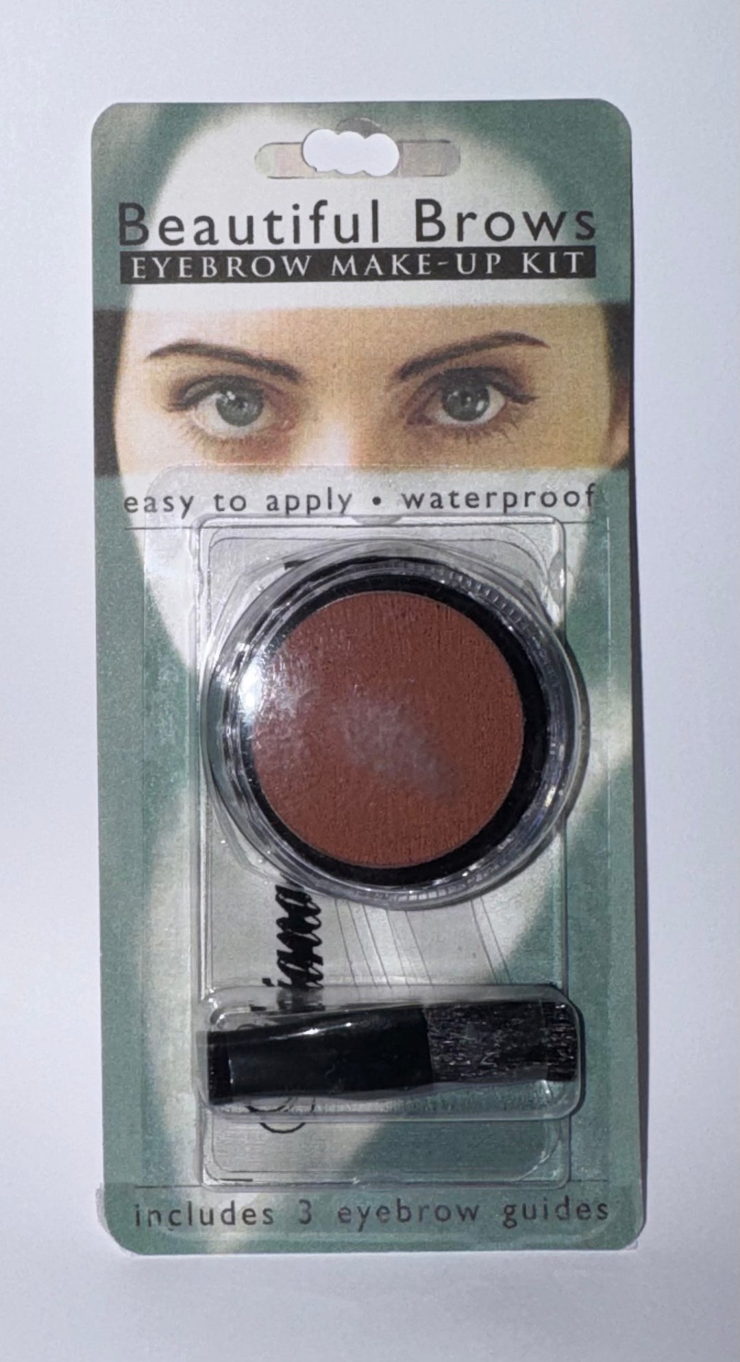 A 'Beautiful Brows Eyebrow Make-Up Kit' in its original blister card packaging, featuring a round pot of brown eyebrow powder and an eyebrow pencil, with a guide book included.