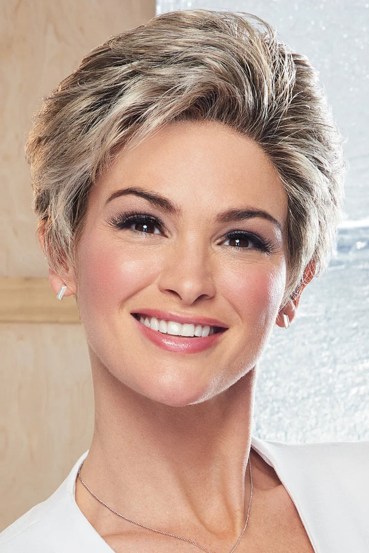 Woman with styled hair against a neutral background