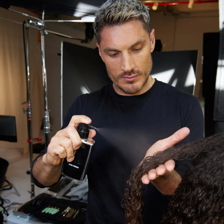 Color Wow Extra Strength Dream Coat Anti-Frizz Treatment image of stylist using product on model