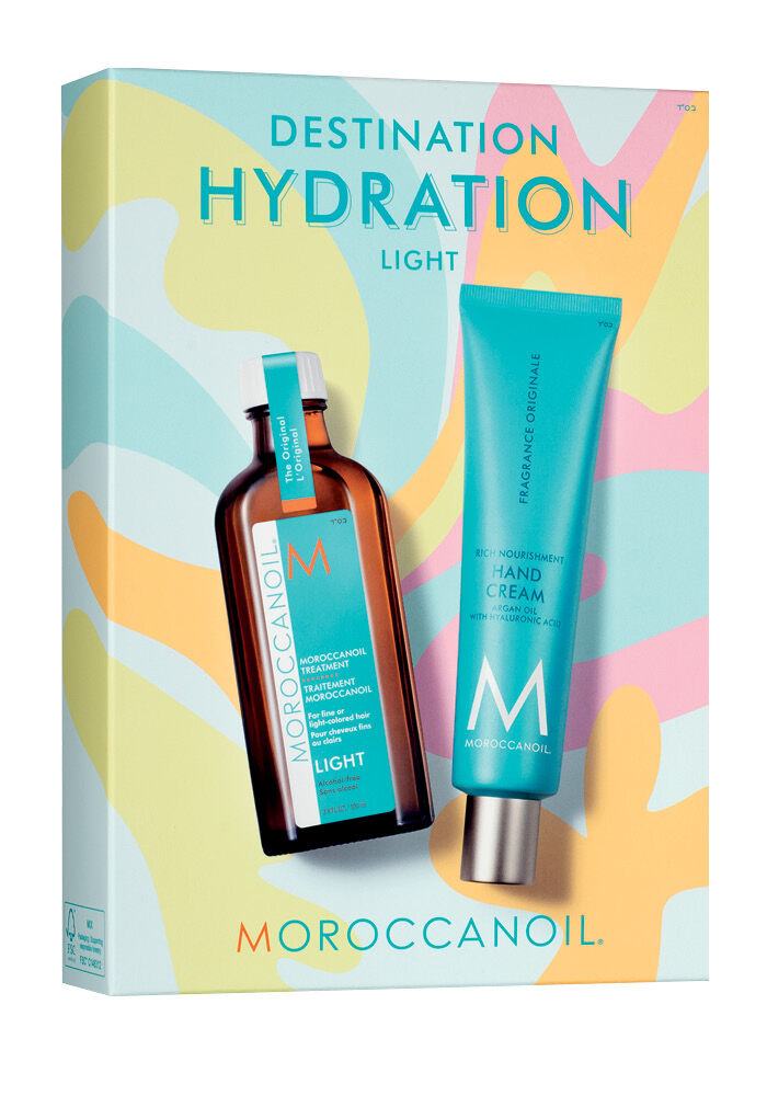 Moroccanoil Destination Hydration Light gift set featuring a Moroccan oil treatment bottle and a hand cream tube on a colorful abstract background.