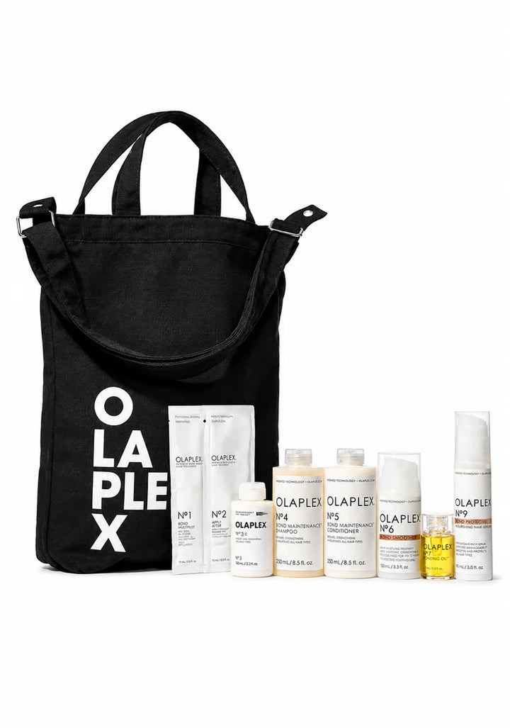 Black tote bag with 'Olaplex' branding next to various Olaplex hair care products on a white background