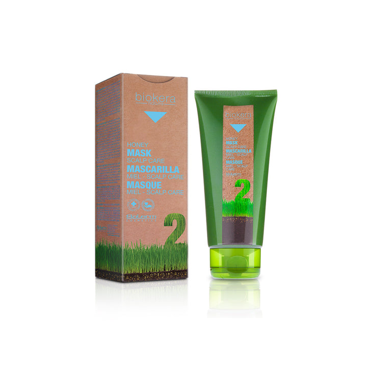 Green tube and brown box of a skincare product on a white background