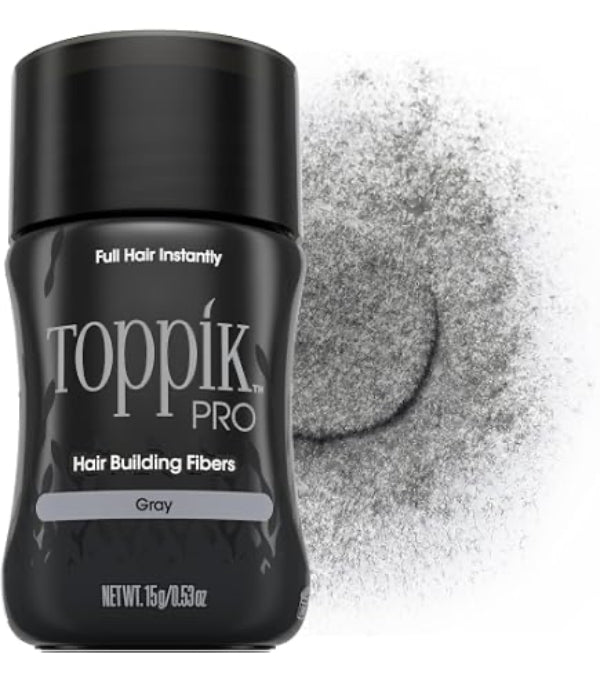 A black bottle of Toppik Pro Hair Building Fibers in Gray, shown next to a textured pile of gray fibers on a white background.